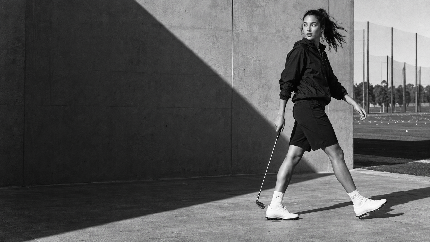 Black-and-white ON FRINGE editorial: a golfer in motion at the practice range